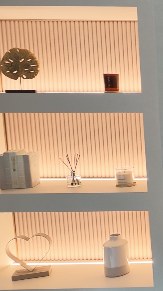 Close-up of the lit shelf niches with fluted backs