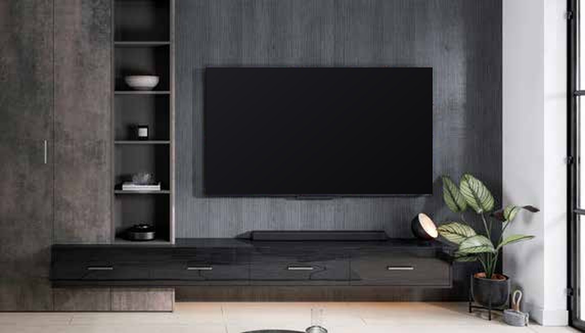 Modern media wall in Plana: textured dark panelling behind the TV, open shelving and a long floating low unit