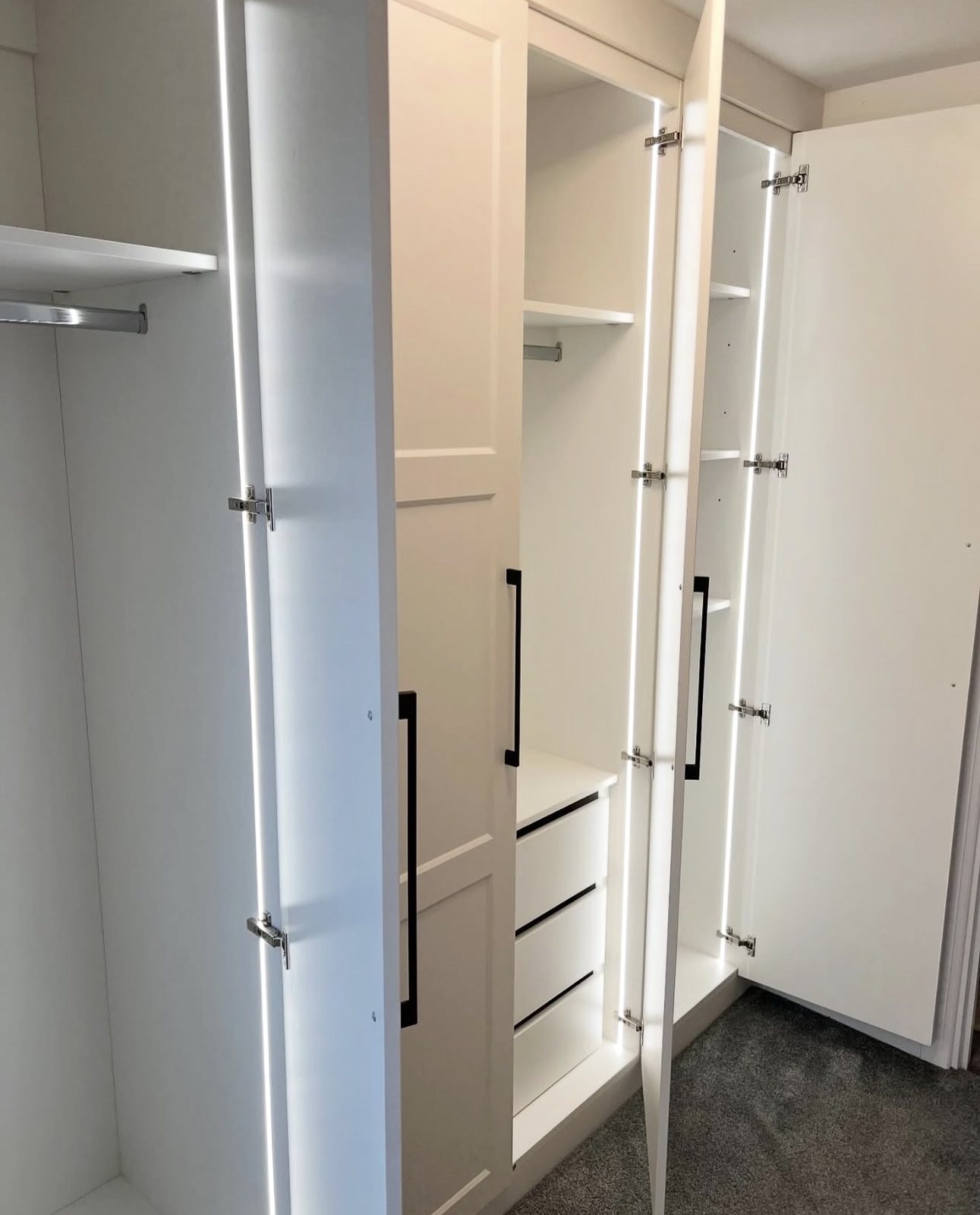 Fitted wardrobes we installed, lit by COB LED strips down each door