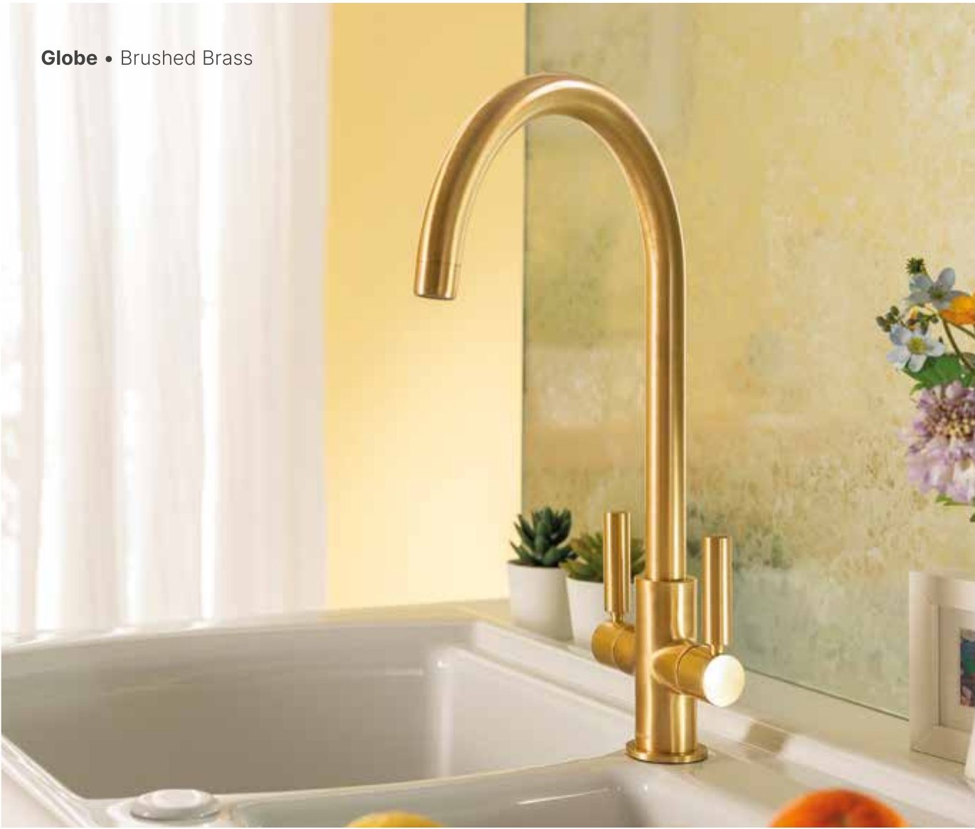 Brushed brass tap over a composite sink